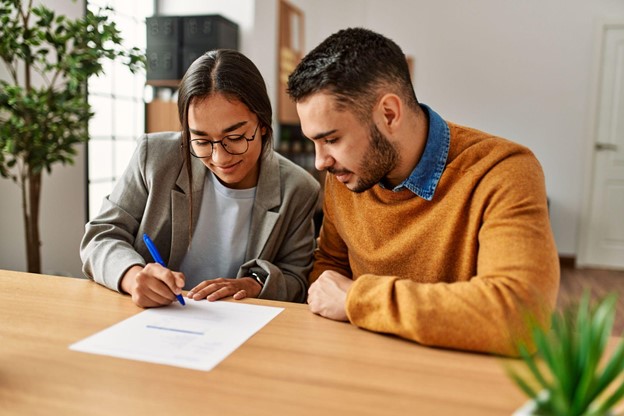 Home buyers signing documents