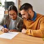 Home buyers signing documents